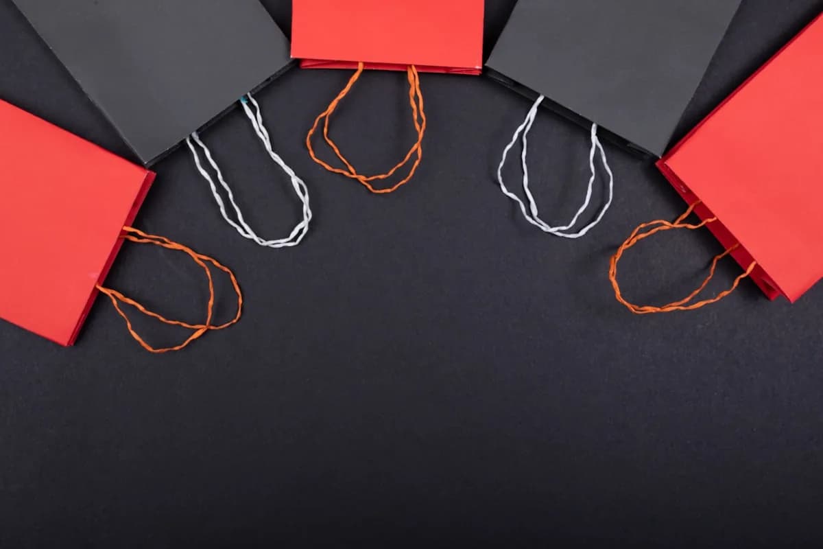 Row of colourful paper shopping bags arranged on a white background, representing merchandising franchise opportunities in the UK.