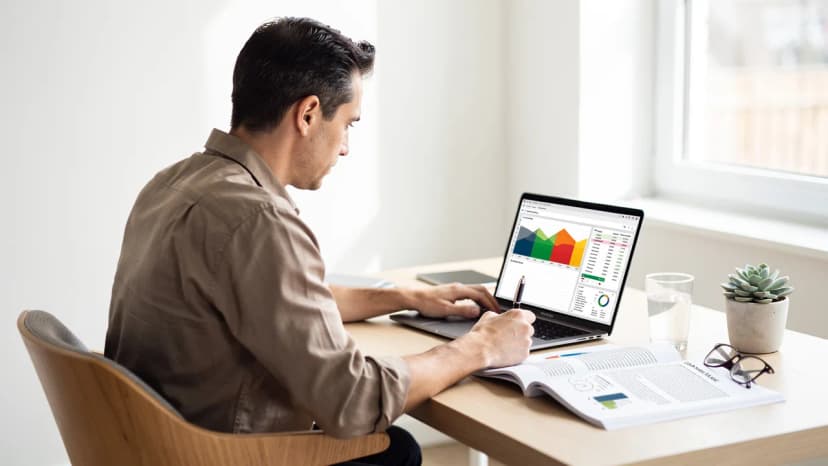 Entrepreneur preparing a strong franchise funding business plan at a UK desk